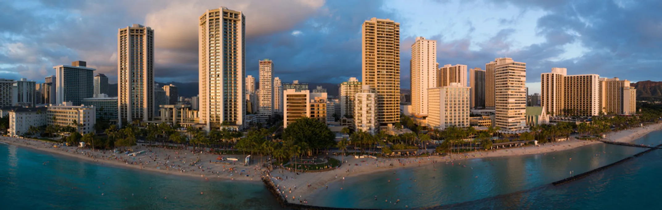 Sunny Poʻipū Beach on Kauaʻi's South Shore with palm trees and turquoise water