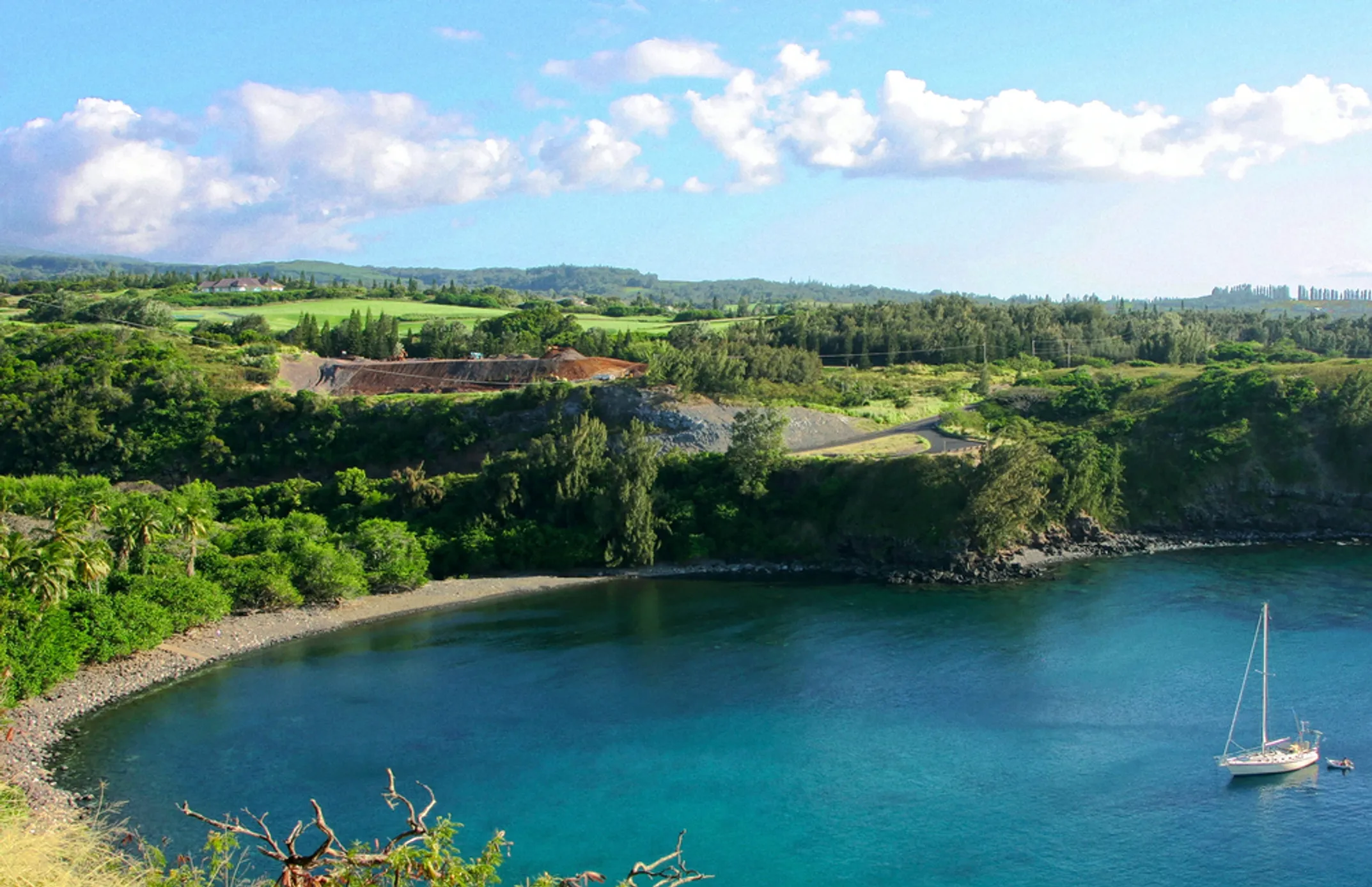 Turquoise waters of Honolua Bay framed by dramatic volcanic rock formations on Maui's west coast