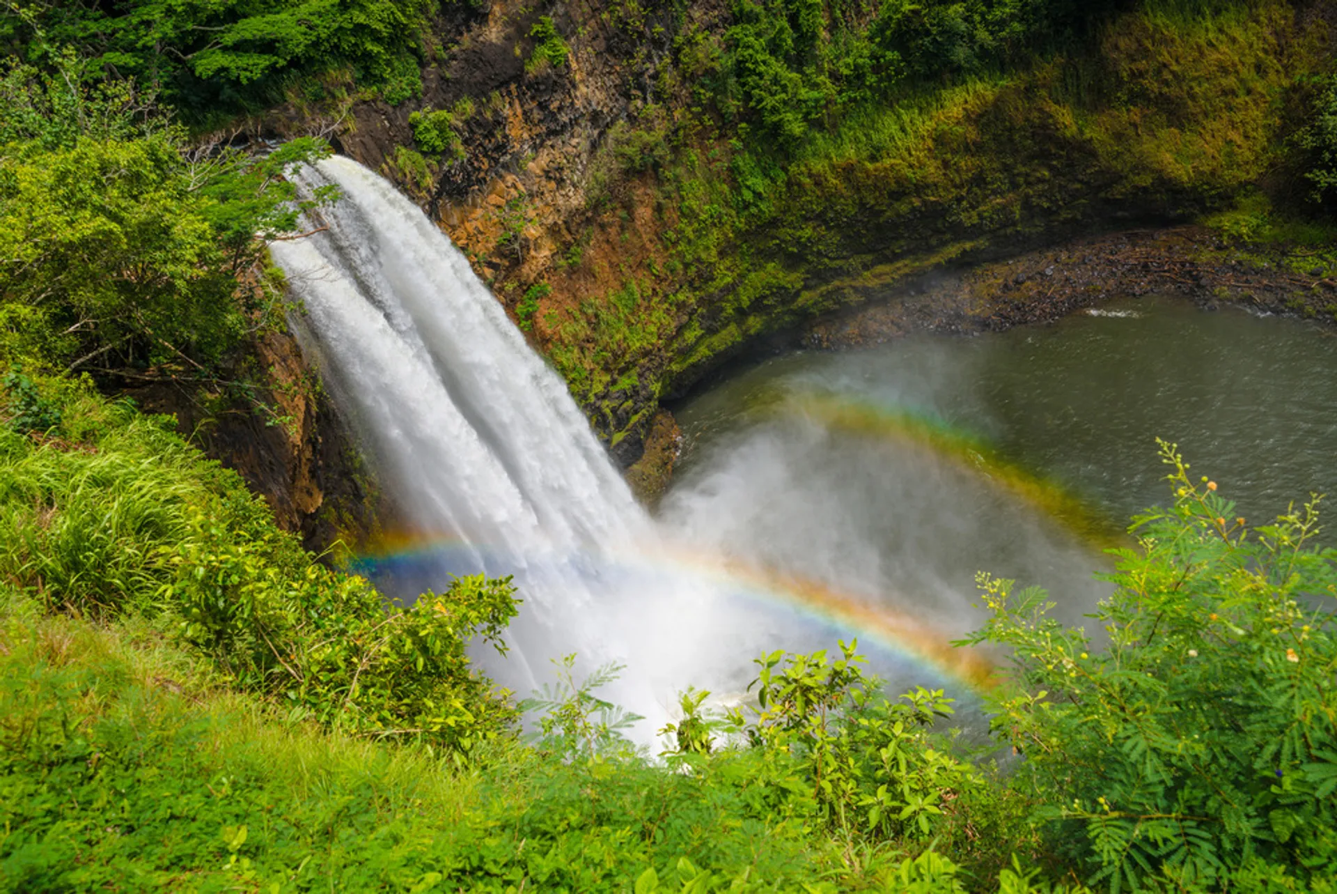Wailua Falls with rainbow in the morning mist