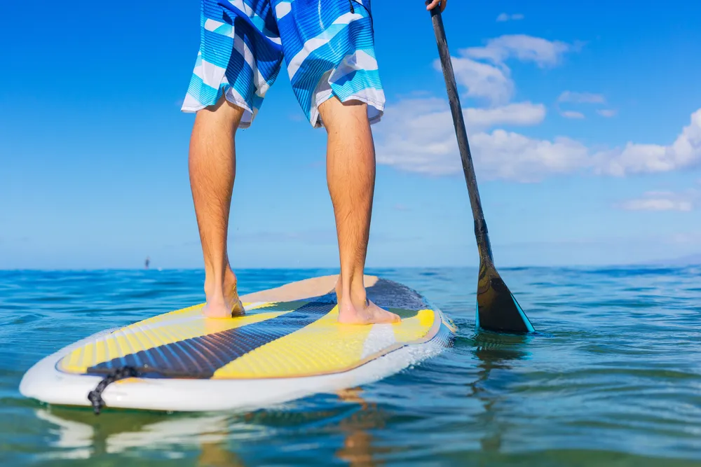 Stand-up paddleboarder on calm Maui waters