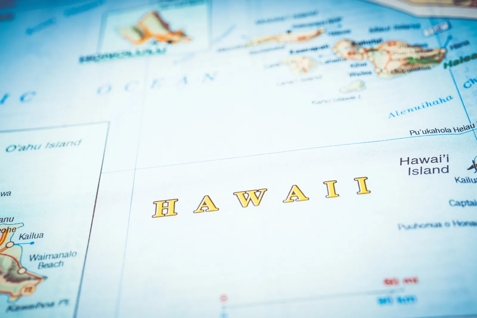Hawaii travel planning with map and airplane at sunset