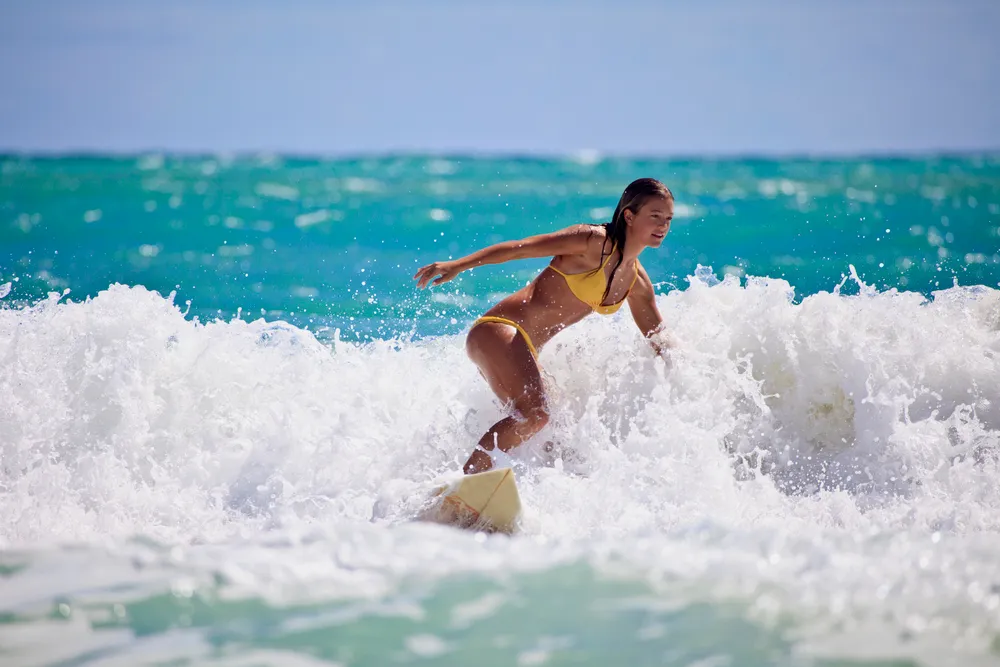 Beginner surfer catching a wave in Maui