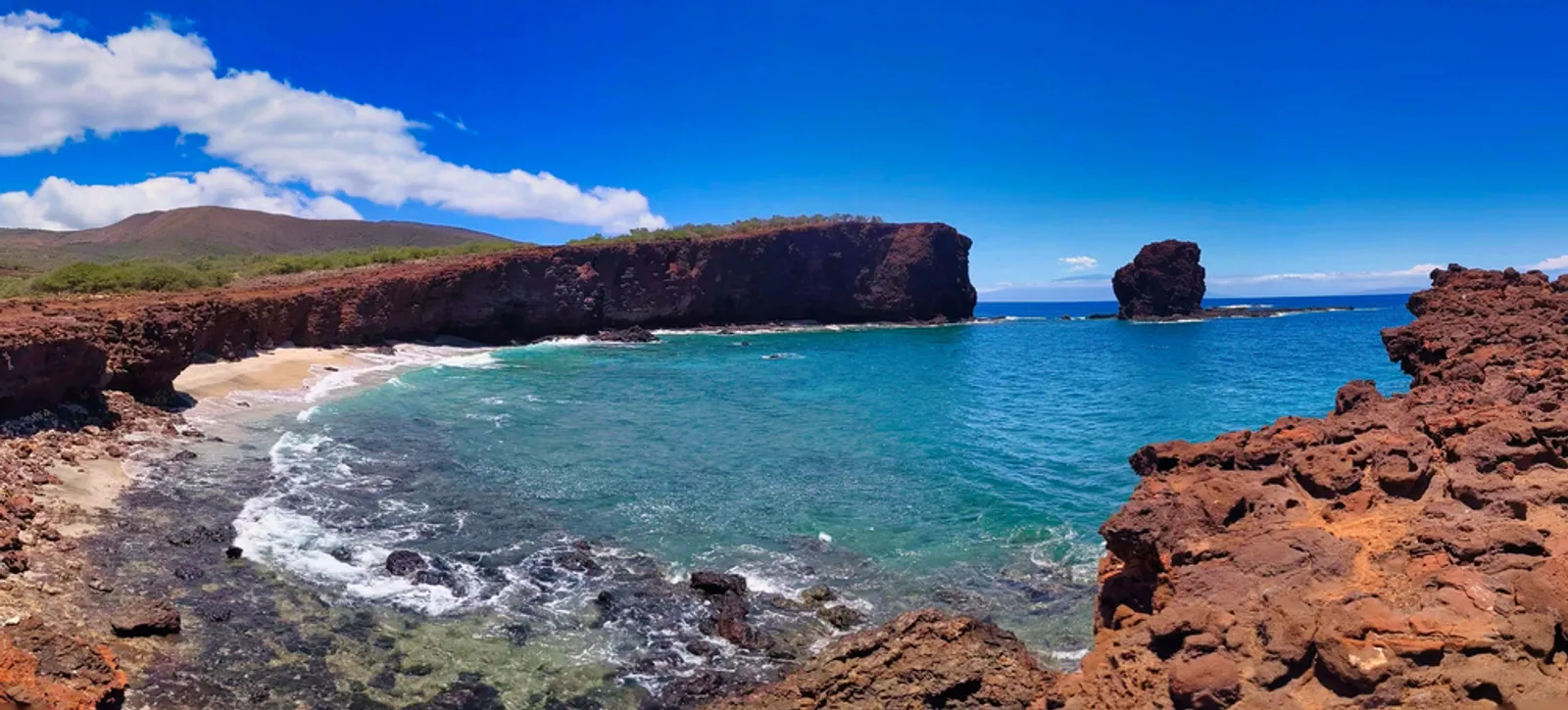 Sweetheart Rock rising from the turquoise Pacific waters