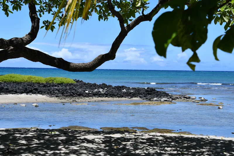Beautiful view of Onekahakaha Beach Park with families enjoying the protected lagoon