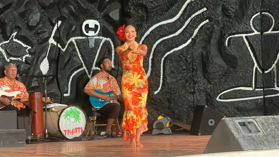 Hula dancer performing at a Big Island luau with live band