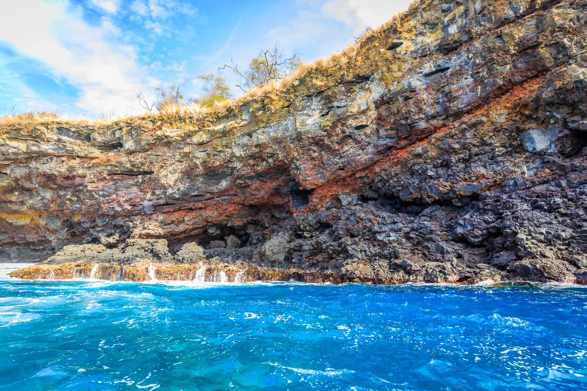 Stunning turquoise waters meeting dramatic volcanic shoreline at Holoholokai Beach Park