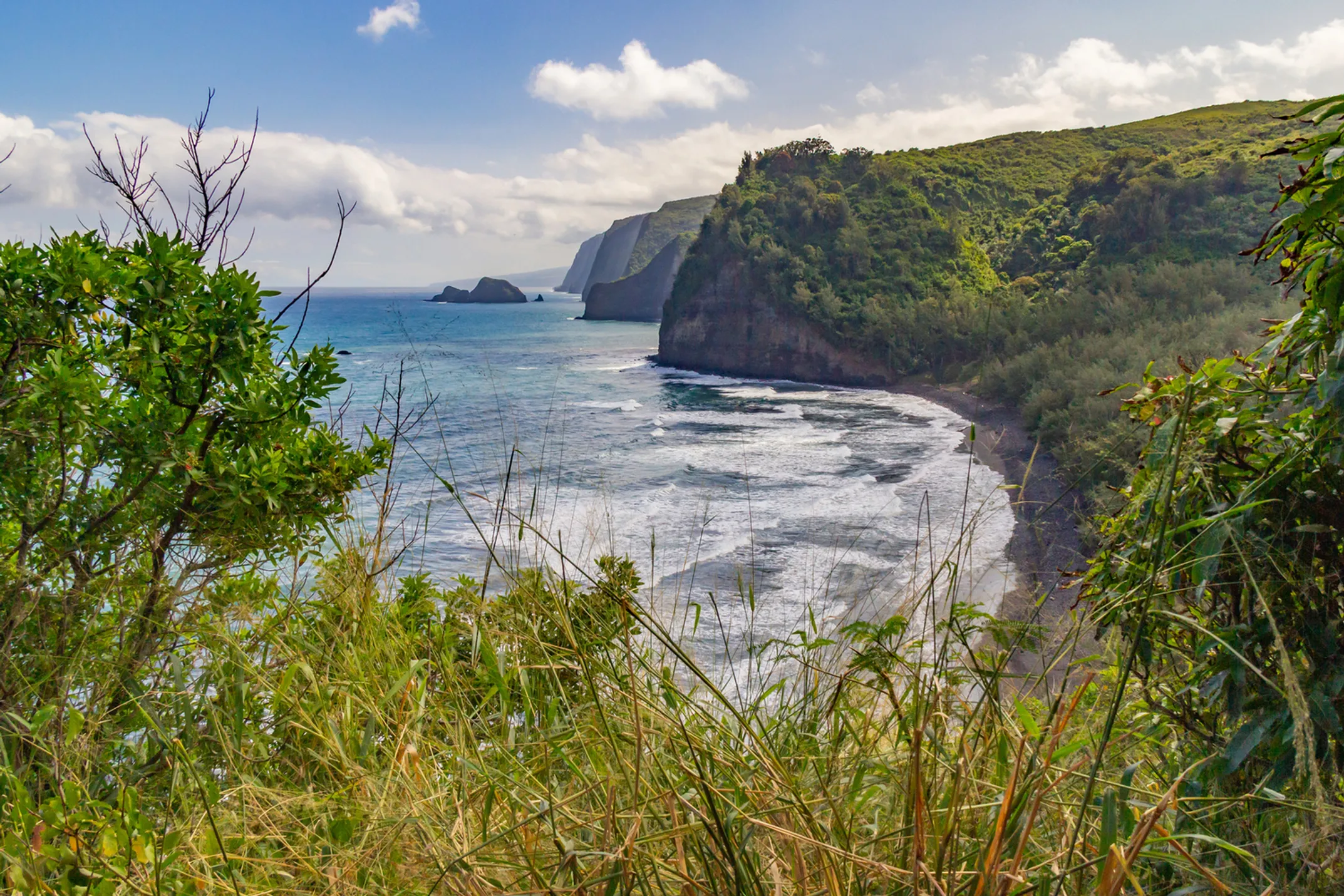 Hikers on the steep Pololū Valley trail