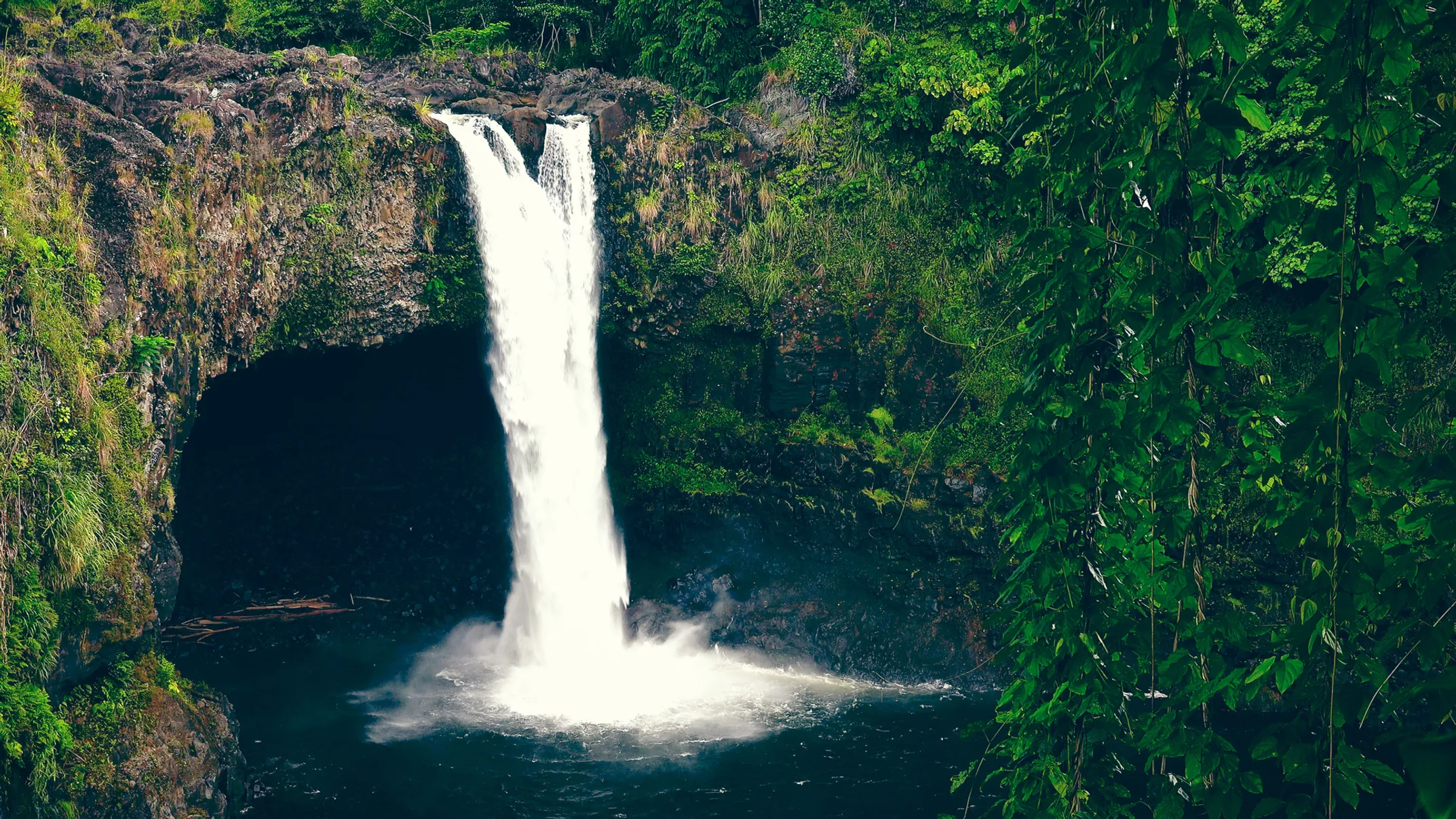 Rainbow Falls with morning rainbows and misty cascades