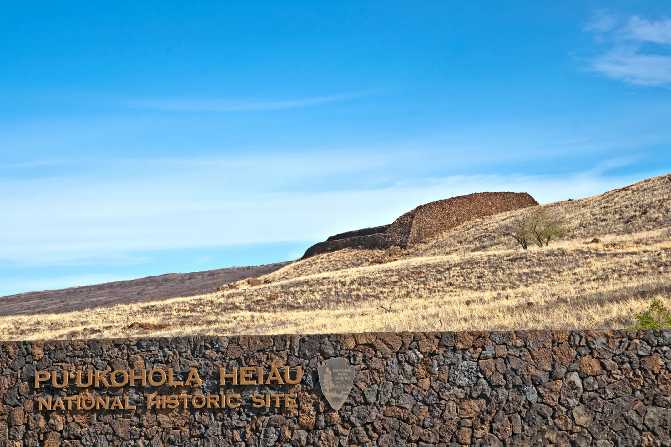 Visitors exploring Puʻukoholā Heiau National Historic Site on the walking trail