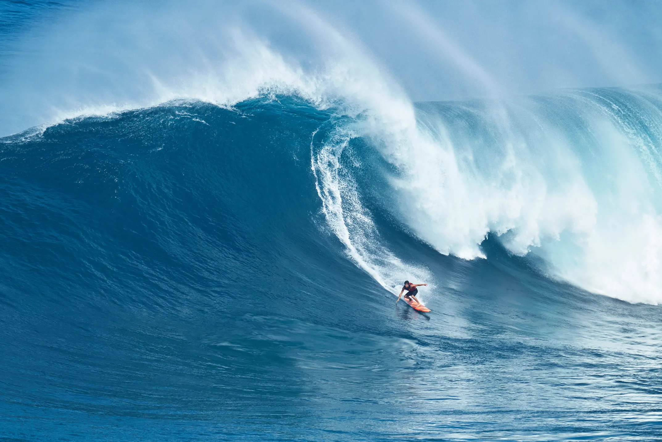 Honoli'i surf breaks with surfers riding waves