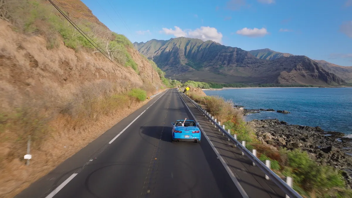 Happy young couple traveling together on Hawaiian road trip adventure