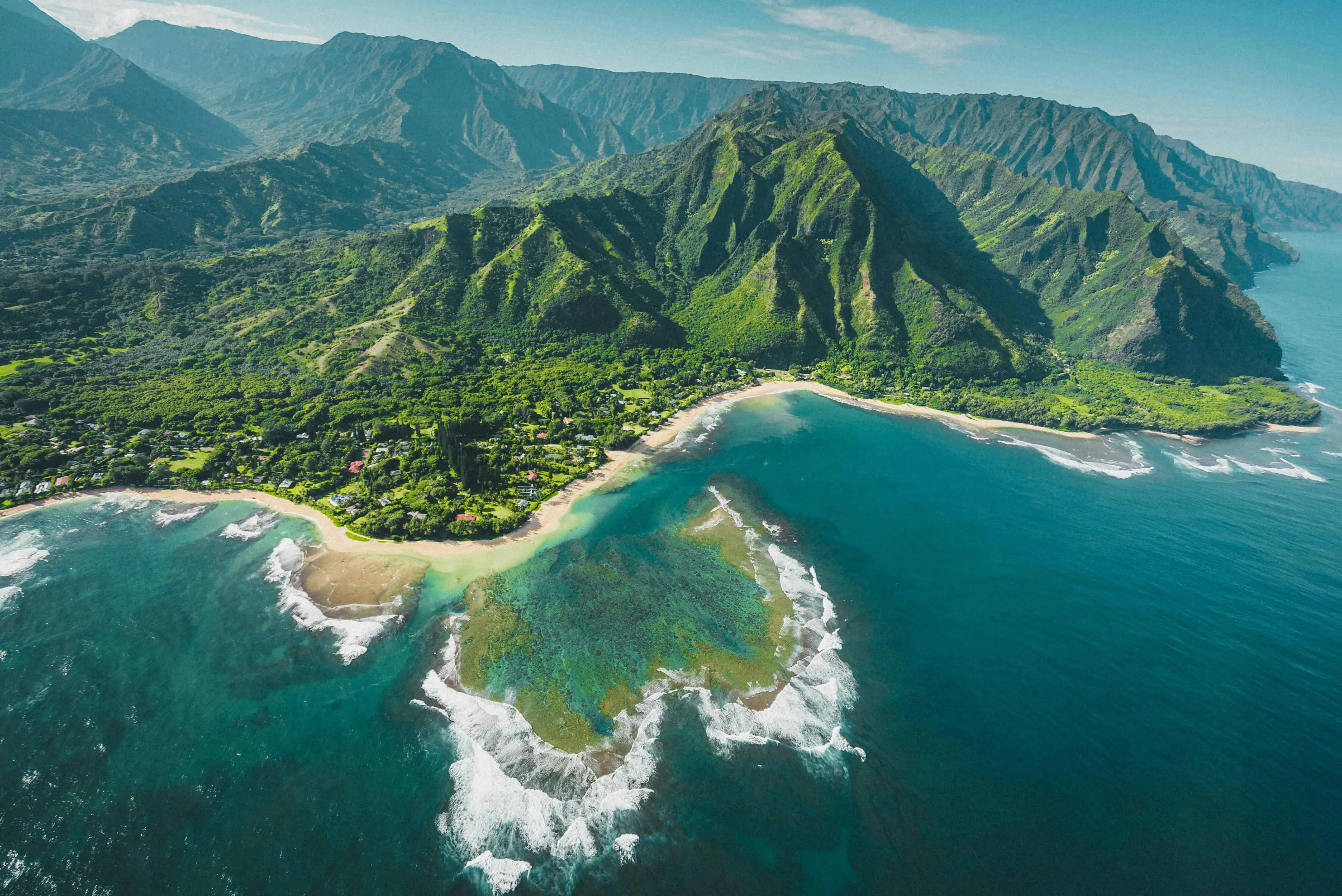 Panoramic view of Hawaiian landscape with volcanic peaks and lush valleys
