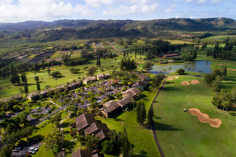 Panoramic view of luxury Kohala Coast resorts with pristine beaches, manicured golf courses, and dramatic volcanic landscape backdrop