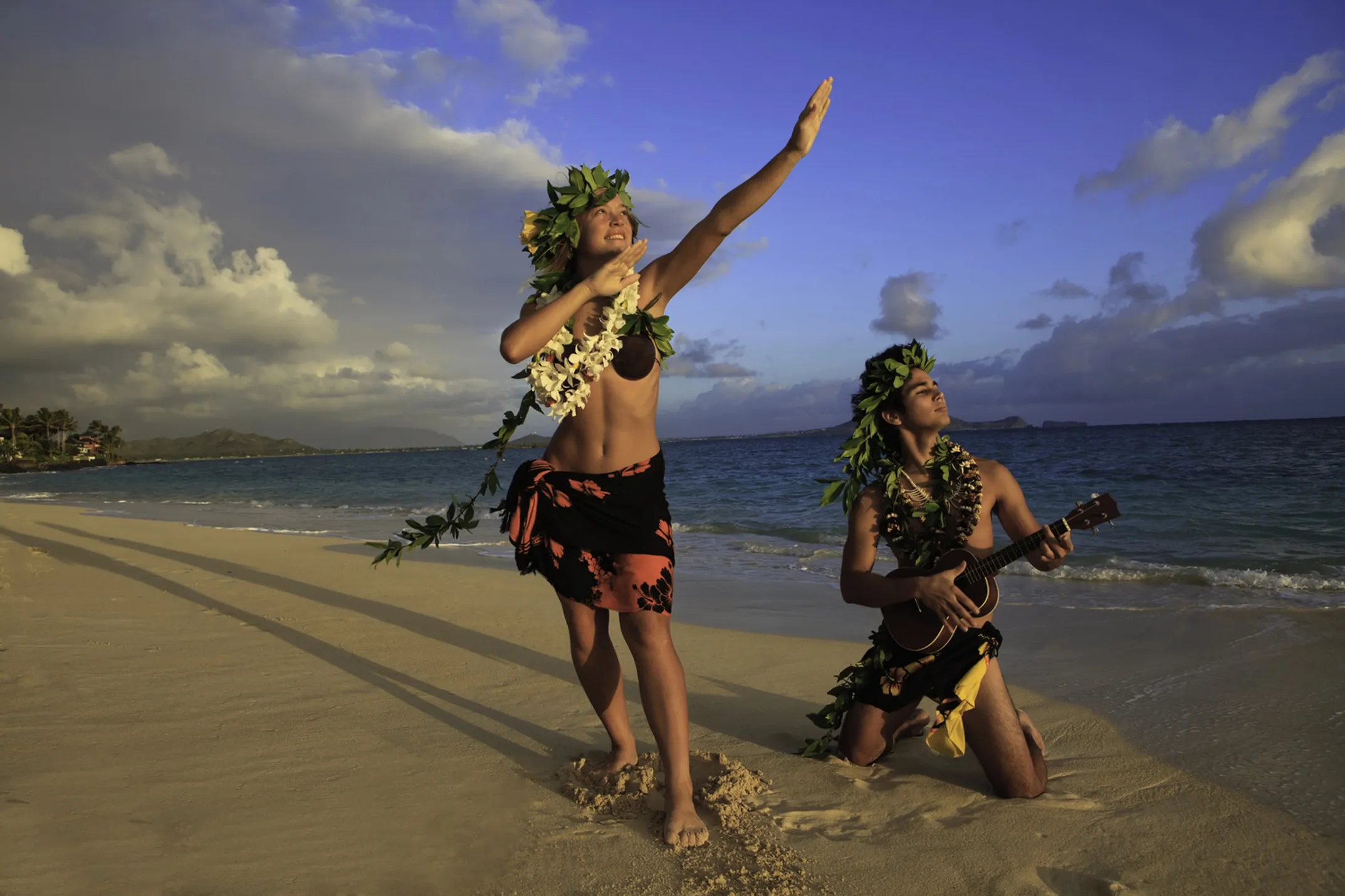 Traditional hālau with kumu hula teaching students around kuahu altar