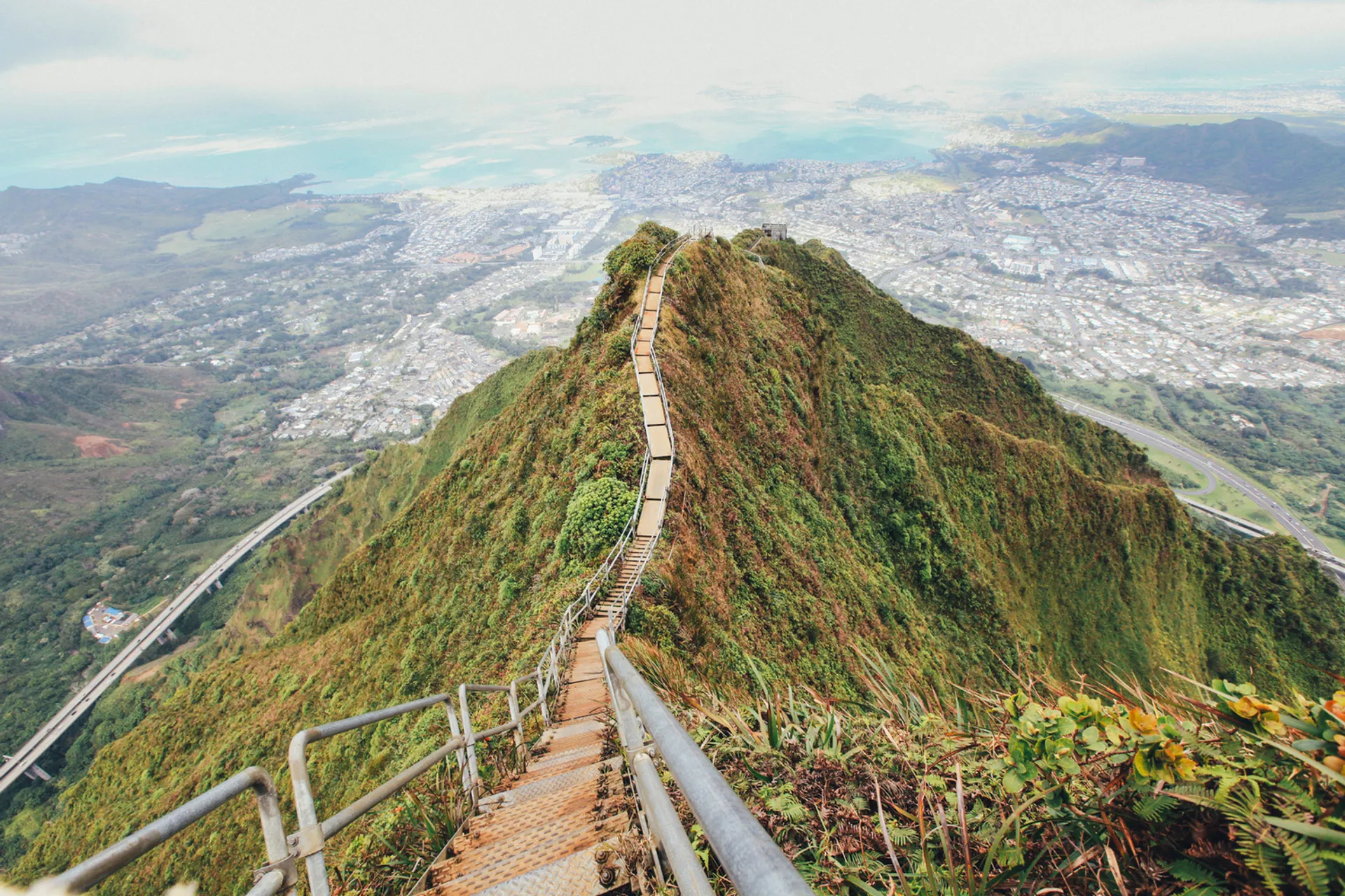 The iconic Haiku Stairs trail on Oahu showcasing dramatic mountain views