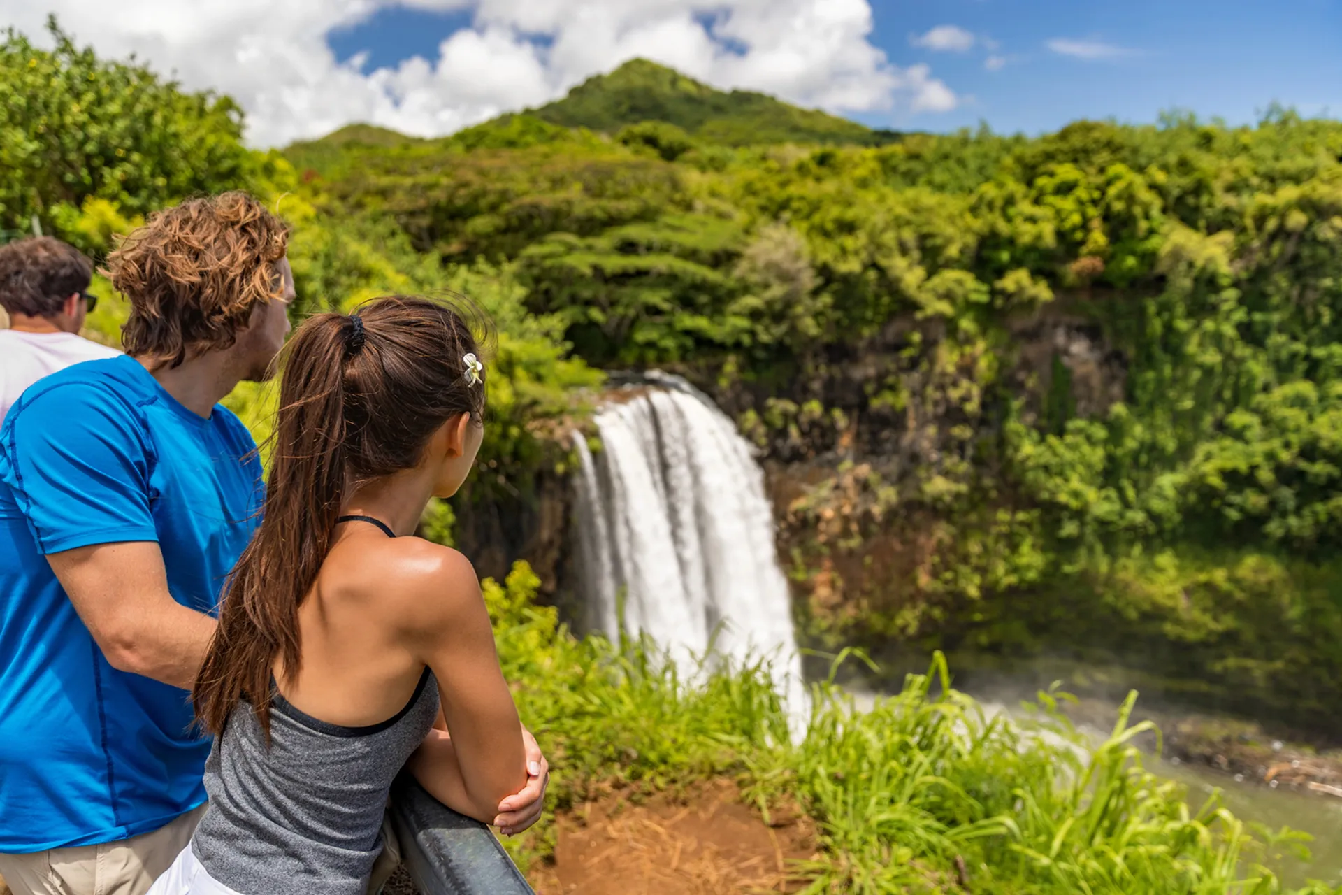 Couple enjoying a scenic waterfall along the Road to Hana in Maui