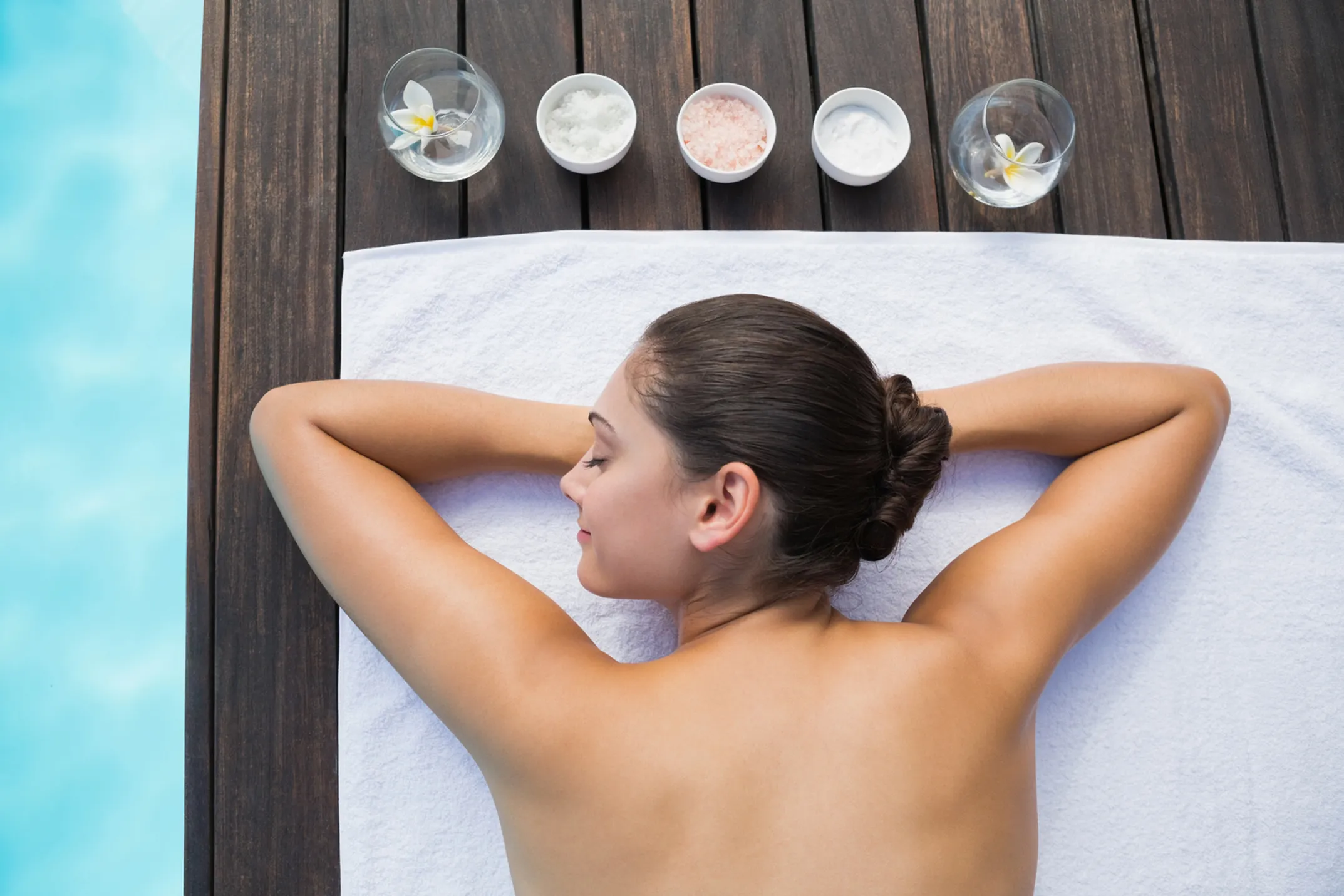 Peaceful Hawaiian spa treatment with woman relaxing and lily flower