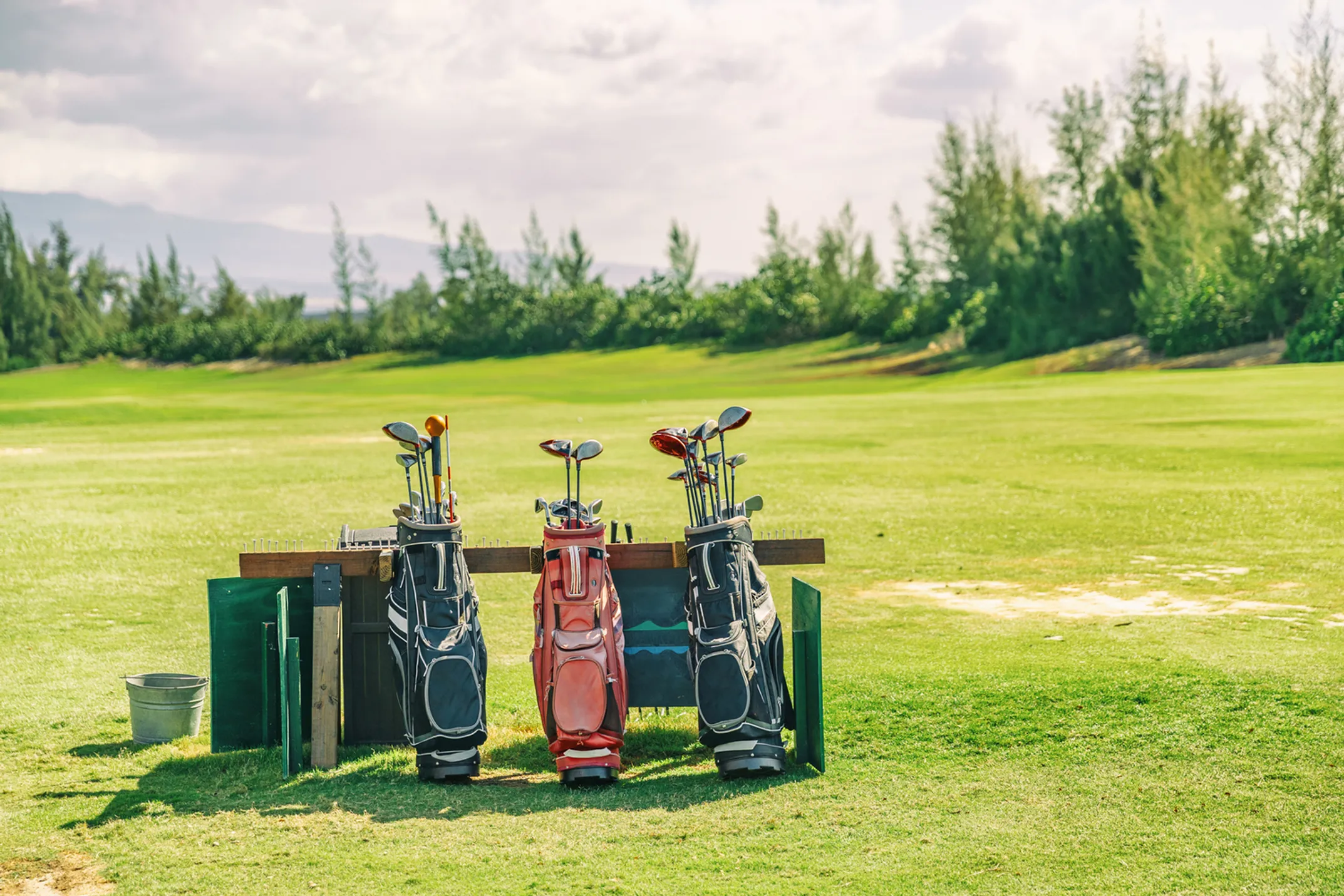 Hawaii's diverse sports culture - golfers at Kapalua, surfers at Pipeline, marathon runners, and traditional Hawaiian games