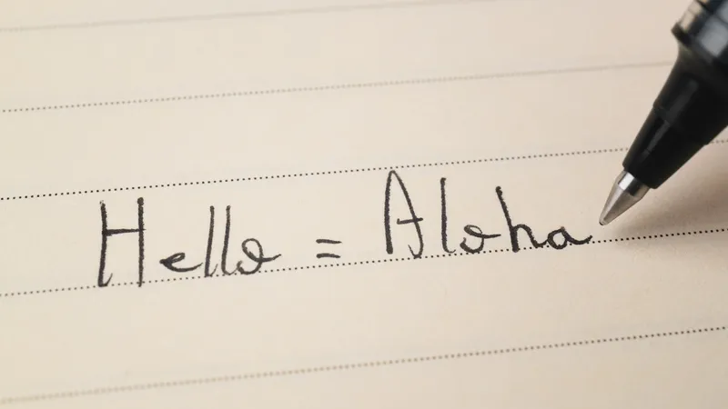 Open book with Hawaiian text and English translation side by side