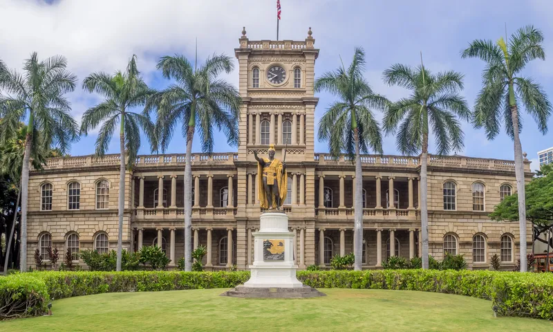 Statue with fresh lei overlooking Hawaiian landscape