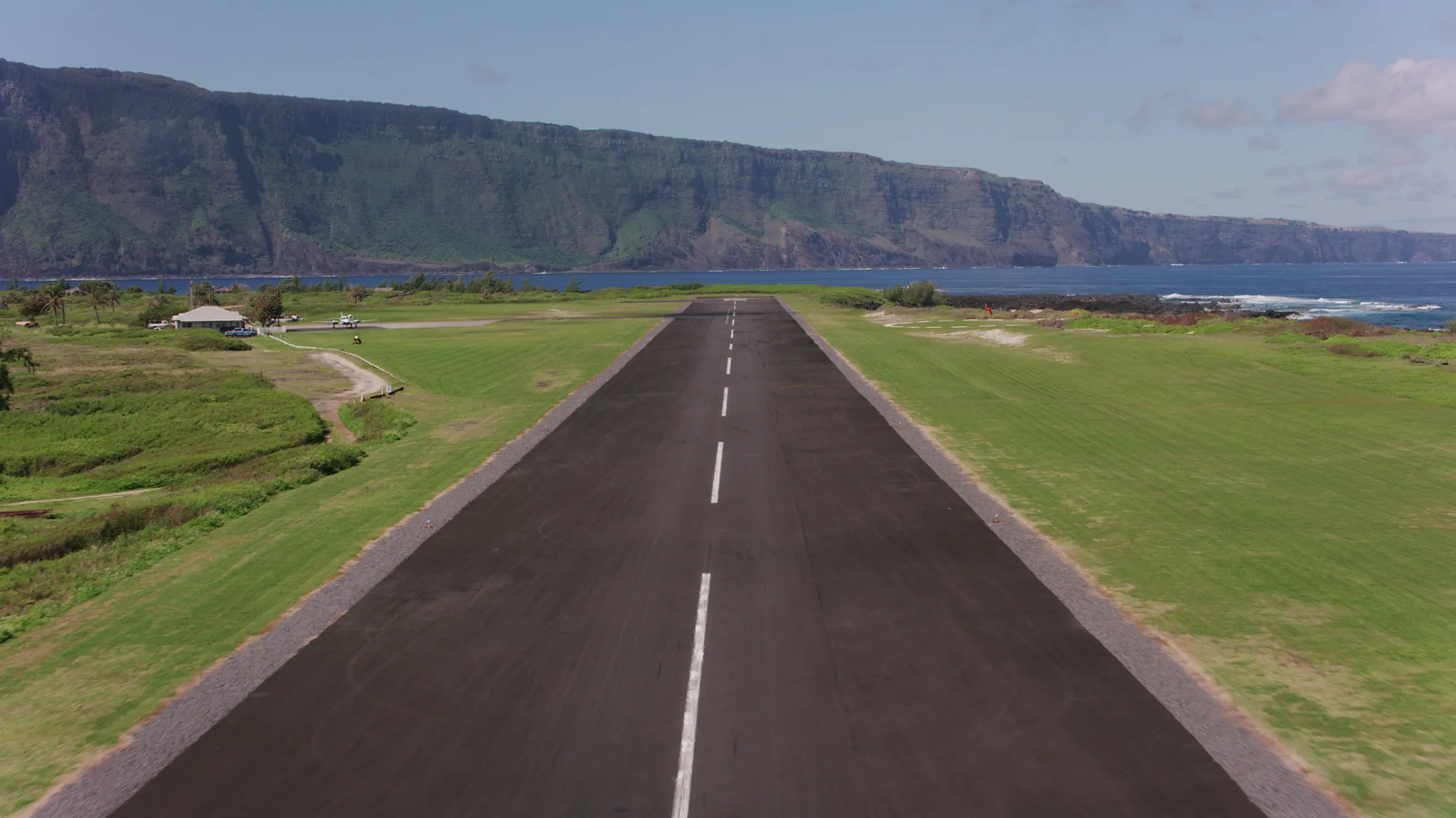 Aerial view of Kalaupapa airport on Molokai coastline - representing respectful travel to Hawaii