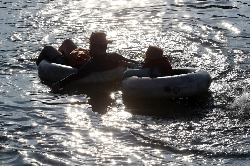 Multi-generational family group enjoying mountain tubing together - showing family-friendly nature