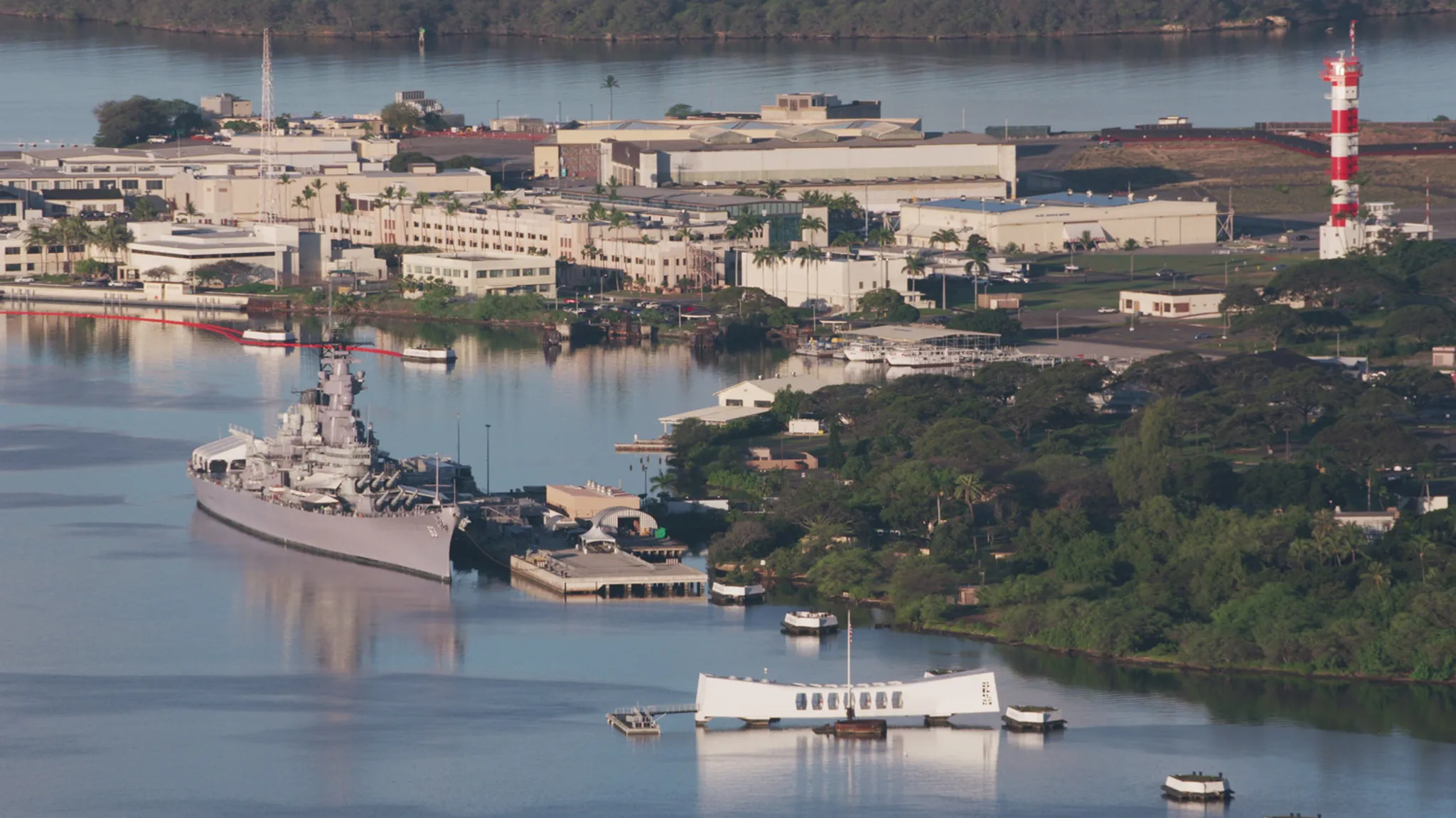 Aerial view of Pearl Harbor with USS Arizona Memorial and battleships