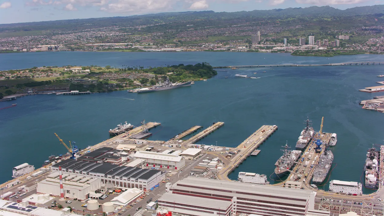 Aerial view of ships in Pearl Harbor showing the naval facilities and surrounding area