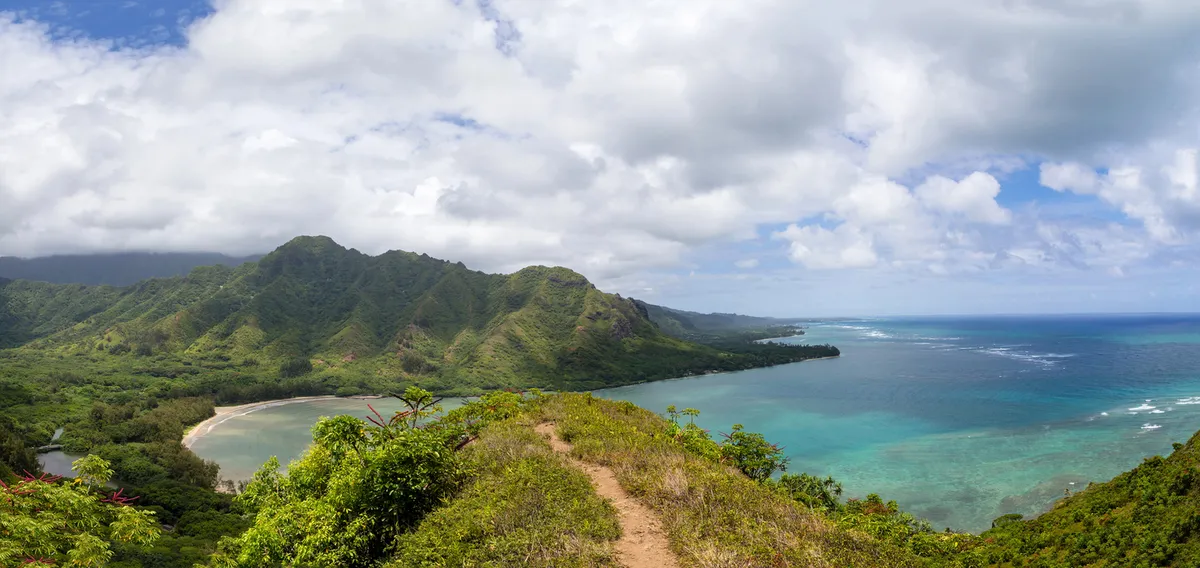 Kauai's dramatic coastline with emerald mountains meeting turquoise waters